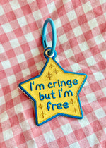 an embroidered patch keychain with a chunky colorful metal key ring. The funny and cute design features a yellow and gold award star that reads "I'm Cringe but I'm free" with sparkles surrounding the text.